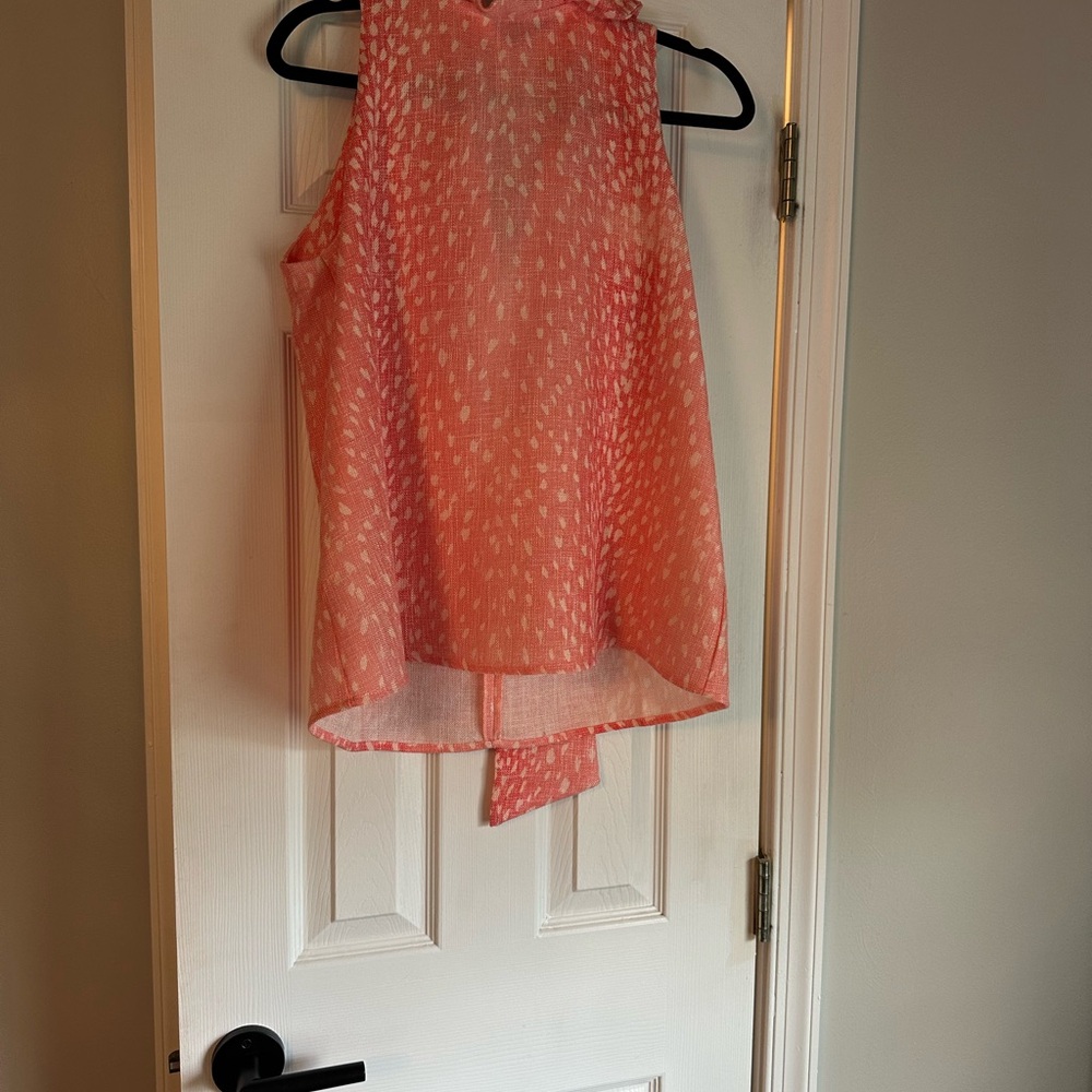 Coral Sleeveless Blouse worn one. Dress up or down. Perfect with white pants.